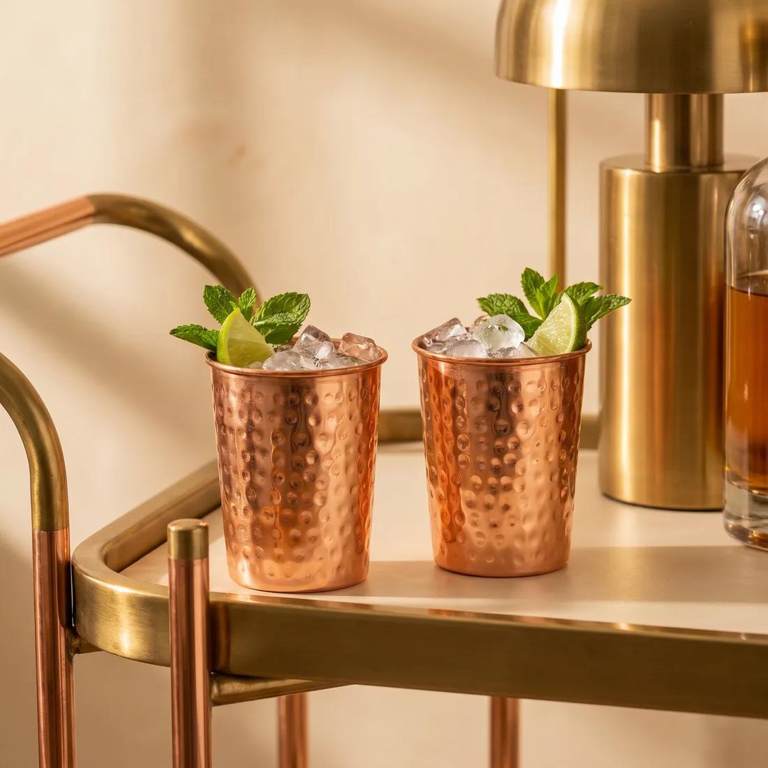 Holding a Coppora copper cup with a deepening patina.