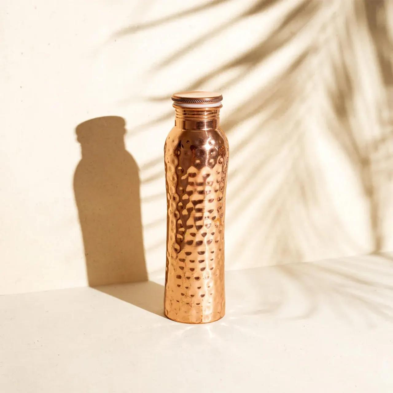 Coppora copper bottle — Hammered finish: The signature — thousands of hand-hammer marks, no two alike.